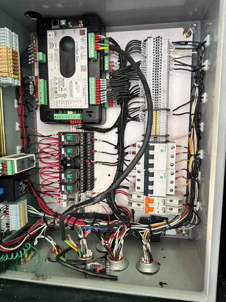 Interior de tablero de sincronismo y distribución con breakers, barras y cableado ordenado